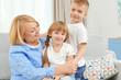 © Africa Studio - Happy grandmother with grandchildren on couch