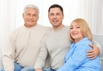 Poster - Adult son with parents on couch