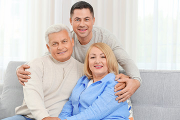 Poster - Adult son with parents on couch