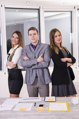 Wall Mural - Young business team. Smiling beautiful women and businessman at the office.