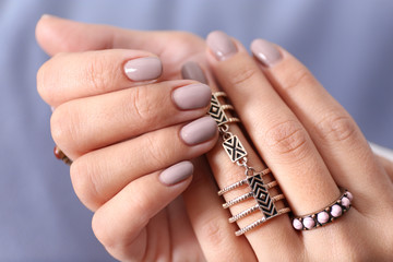 Canvas Print - Close up view of female hands with beautiful manicure on blurred color background