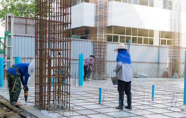 Construction workers building the foundation of a building.