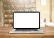 © BrightSpace - Laptop with blank screen on table. interior background, bookshel