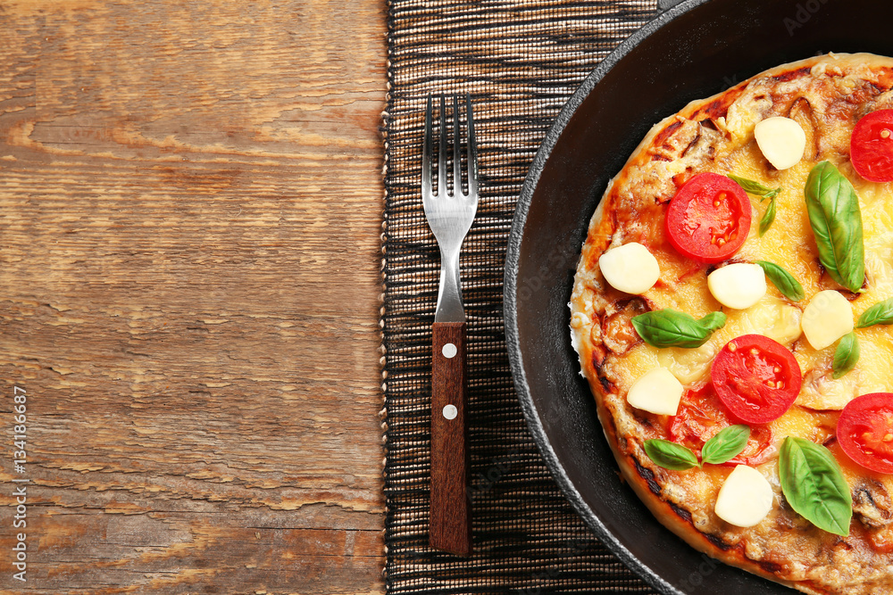 Freshly baked pizza in a pan