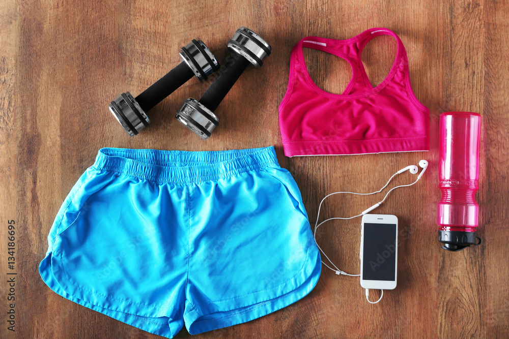 Fitness equipment on wooden background