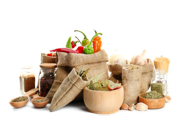 Wall Mural - Spices in sacking bags on white background