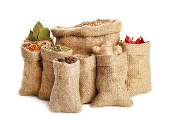 Wall Mural - Spices in sacking bags on white background