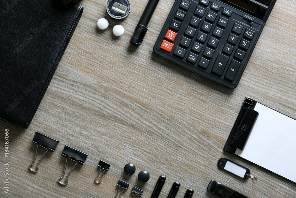Flat lay of black stationery on wooden table