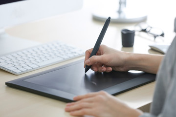 Canvas Print - Female hands using graphic tablet in office