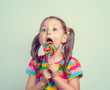 © Myst - beautiful cute little girl eating lollipop