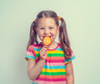 © Myst - beautiful cute little girl eating lollipop