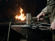 The hands of a blacksmith at work in the smithy