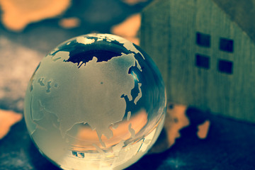 Crystal Globe with House on Grunge World Map