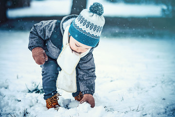 Adorable little boy having fun on winter day