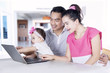 © Creativa Images - Young parents and child using laptop
