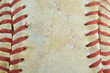Macro image of the laced seams of a weathered and beaten old baseball. Sports background. Copy space