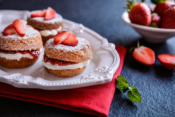 Wall Mural - Mini Victoria sponge cakes with whipped cream and strawberries