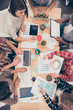 © deagreez - Top view of working table of multiethnic young managers preparin