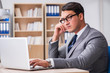 © Elnur - Young businessman sitting at the desk