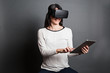© Manuel - young woman using virtual reality glasses and a tablet computer