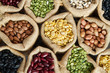 © piyaset - Various whole grain legumes in sack, top view