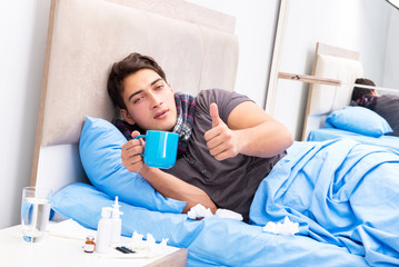 Sick man with flu lying in the bed