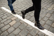 © Wedding photography - Legs of couple, woman and man walking on crosswalk in paving stone. Follow me concept