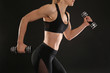 © Africa Studio - Young athletic woman with dumbbells on black background, closeup