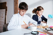 © Drobot Dean - Serious little children using laptop and having breakfast