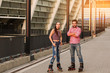 Young couple wearing inline skates. Man with crossed arms standing. We live by sport.