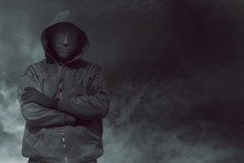 Hooded Man With Mask Standing Alone