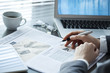 © sebra - Businesswoman reading newspaper on worktable
