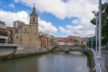 Wall Mural - The church Iglesia de San Anton at the Nervion river in Bilbao. The church, constructed 1510, is a Catholic temple located in the Old Town. It is build in gothic style with baroque elements