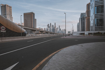 Wall Mural - Dubai downtown in the evening, luxury modern buildings in bright yellow sunrise light, futuristic cityscape of United Arab Emirates.