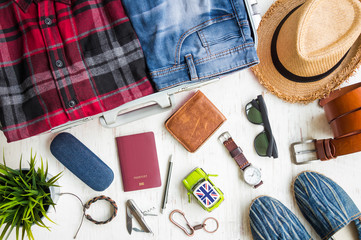 Sticker - Travel preparations, men's casual outfits with accessories on white rustic wooden background