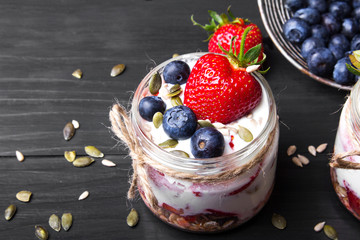 Wall Mural - delicious dessert - yogurt with strawberries and blueberries