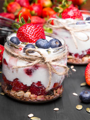 Wall Mural - delicious dessert - yogurt with strawberries and blueberries