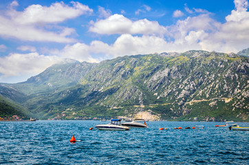 beautiful mediterranean landscape. Mountains and fishing boats near town Perast, near town Perast, Kotor bay (Boka Kotorska), Montenegro, Europe