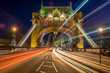Tower Bridge, London at night with moving traffic.
