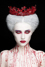 Mysterious Beauty Portrait Of Snow Queen Covered With Blood. Bright Luxury Makeup. White Demon Eyes.