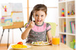 © Oksana Kuzmina - kid girl eating healthy food at home