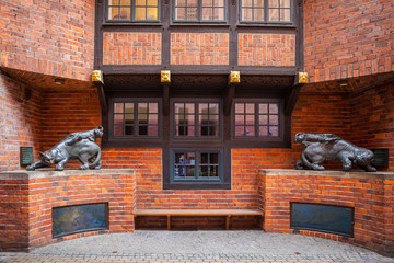 Old brick houses' alcove in old town decotated by wild cats statues