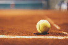 Yellow Tennis Bal On Empty Court, Blurred Background With Area For Your Text Message Or Content