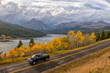 Truck passing fall foliage on western Montana highway