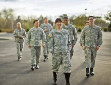 Group Of US Smiling Army Soldiers Walking Outdoors