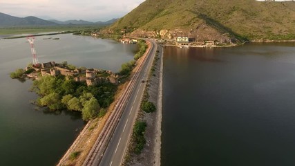 Wall Mural - The Skadar lake and dam with railways and highways. Fort Lesendro is on island. Aerial view. Montenegro
