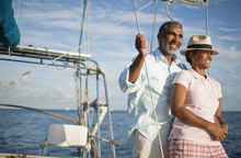 Mature Couple Enjoying View Of Water From Boat Deck.
