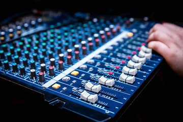 Canvas Print - Sound manager is working on the audio mixer, preparing new mix of a song or work on live event