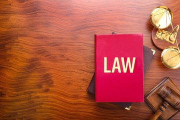 Wall Mural - Judge gavel with scales and books on wooden background