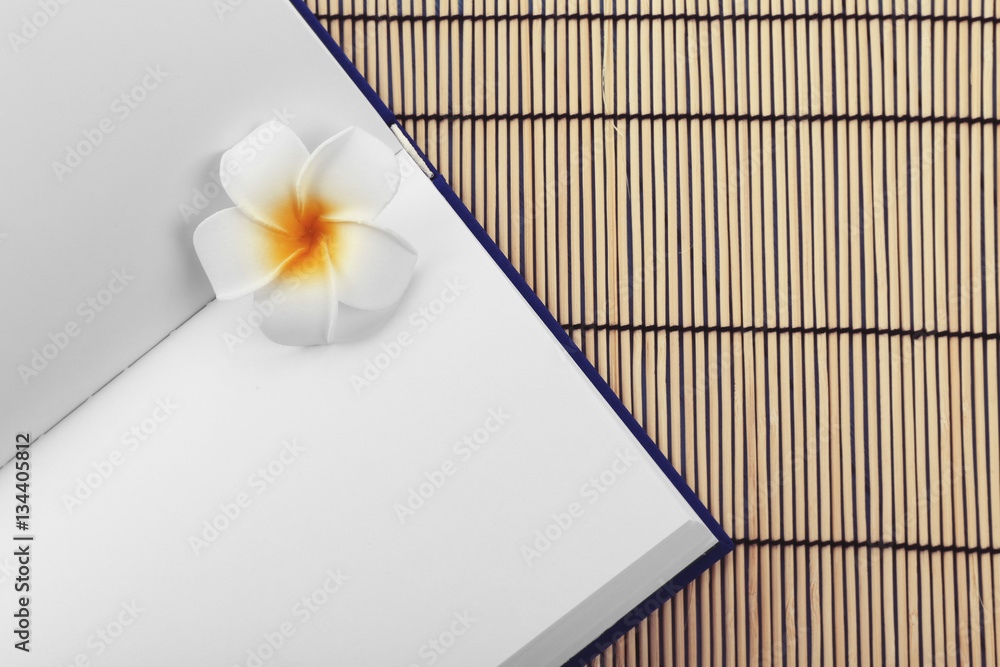 Book on bamboo mat background